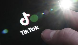 The TikTok startup page is displayed on an iPhone in Ottawa, Ontario, Monday, Feb. 27, 2023. The federal government is banning TikTok from its mobile devices just days after federal and provincial privacy commissioners launched an investigation into the social media platform. (Sean Kilpatrick/The Canadian Press via AP)