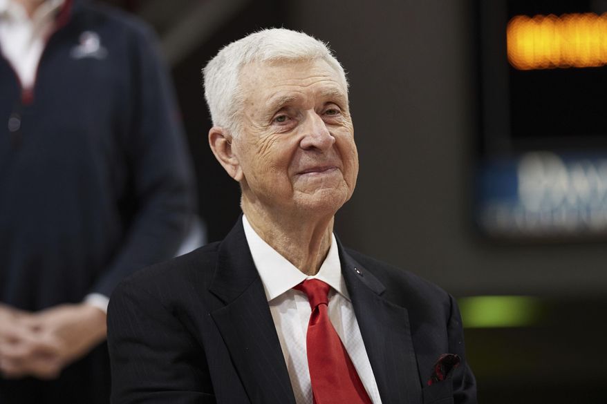 Former Davidson basketball player, coach, and Athletic Director, and former Virginia coach, Terry Holland, smiles during a ceremony to retire his jersey number 42 following an NCAA college basketball game between LaSalle and Davidson on Sunday, Jan. 30, 2022, in Davidson, N.C. Terry Holland, who elevated Virginia basketball to national prominence during 16 seasons as coach and later had a distinguished career as an athletic administrator, has died, the school announced Monday, Feb. 27, 2023. He was 80. (AP Photo/Brian Westerholt, File) **FILE**