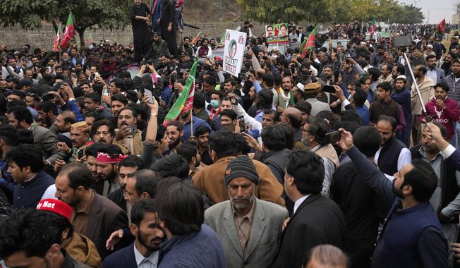 Supporters of former Pakistani Prime Minister Imran Khan move with a vehicle, center, carrying their leader Khan arriving for his court appearance, in Islamabad, Pakistan, Tuesday, Feb. 28, 2023. A Pakistani court approved bail for Khan after he appeared before a judge in Islamabad amid tight security, officials said, months after police filed terrorism charges against the country&#x27;s popular opposition leader for inciting people to violence. (AP Photo/Anjum Naveed)