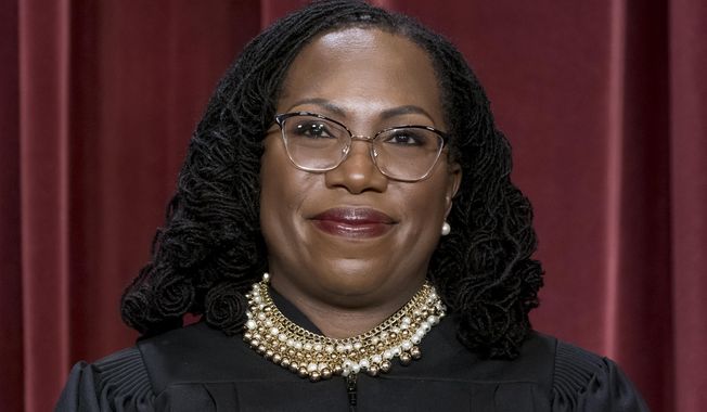 Associate Justice Ketanji Brown Jackson stands as she and members of the Supreme Court pose for a new group portrait following her addition, at the Supreme Court building in Washington, Oct. 7, 2022. Jackson has written her first majority opinion for the Supreme Court. The opinion released Tuesday in a dispute between states over unclaimed money is one of roughly a half dozen she is expected to write by the time the court finishes its work for the summer, usually in late June. The decision was unanimous, though all the justices didn’t join the whole opinion. (AP Photo/J. Scott Applewhite, File)