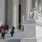 People walk down the Supreme Court steps on Capitol Hill in Washington, Tuesday, Feb. 28, 2023, after the first of two hearings over President Joe Biden&#x27;s student debt relief plan. (AP Photo/Patrick Semansky)