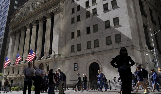 Visitors to the financial district walk past the New York Stock Exchange, Friday, Sept. 23, 2022, in New York. (AP Photo/Mary Altaffer, File)