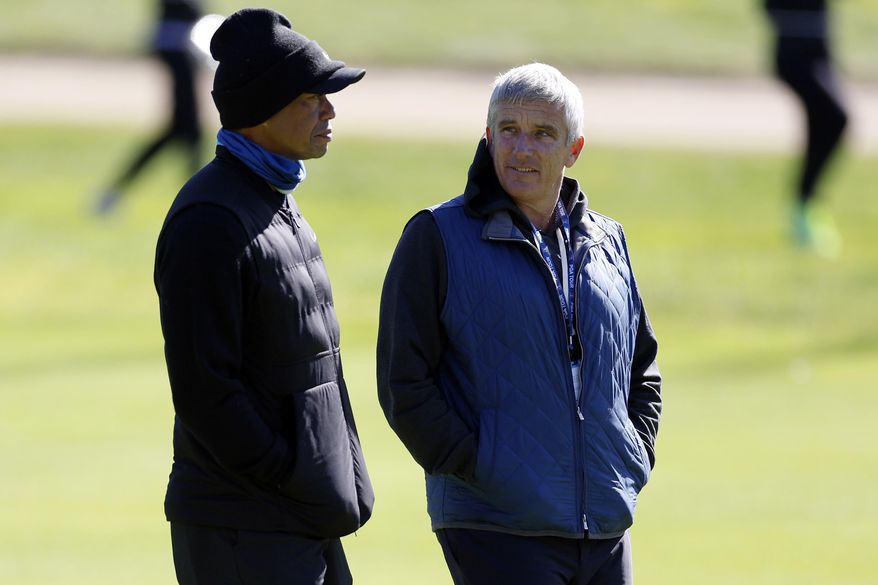 Tiger Woods, left, talks to PGA Commissioner Jay Monahan on the 15th hole during the pro-am of the Genesis Invitational golf tournament at Riviera Country Club, Wednesday, Feb. 15, 2023, in the Pacific Palisades area of Los Angeles. (AP Photo/Ryan Kang) **FILE**