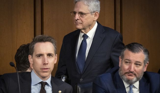 Attorney General Merrick Garland, center, walks past Sen. Josh Hawley, R-Mo., front left, and Sen. Ted Cruz, R-Texas, as he arrives to testify to the Senate Judiciary Committee as they examine the Department of Justice, at the Capitol in Washington, Wednesday, March 1, 2023. (AP Photo/Jacquelyn Martin)