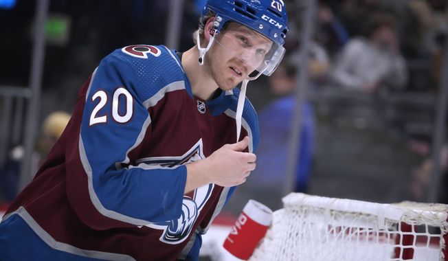 Colorado Avalanche center Lars Eller, just acquired from the Washington Capitals, warms up before the second period of the team&#x27;s NHL hockey game against the New Jersey Devils on Wednesday, March 1, 2023, in Denver. (AP Photo/David Zalubowski)