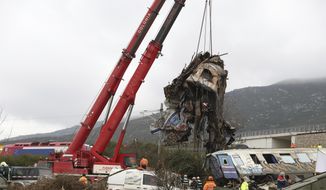 Cranes remove debris after a trains&#x27; collision in Tempe, about 376 kilometres (235 miles) north of Athens, near Larissa city, Greece, Thursday, March 2, 2023. Rescuers using cranes and heavy machinery on Thursday searched the wreckage of trains involved in a deadly collision that sent Greece into national mourning and prompted strikes and protests over rail safety. (AP Photo/Vaggelis Kousioras)