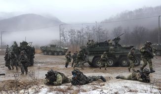 U.S. and South Korean army soldiers, left, come out from their armored vehicles during a joint military drill between South Korea and the United States in Paju, South Korea on Jan. 13, 2023. The South Korean and U.S. militaries said Friday, March 3, they&#x27;ll go ahead with large-scale annual military drills later this month despite North Korea&#x27;s threats to take &quot;unprecedently&quot; strong action against such training.(AP Photo/Ahn Young-joon) **FILE**