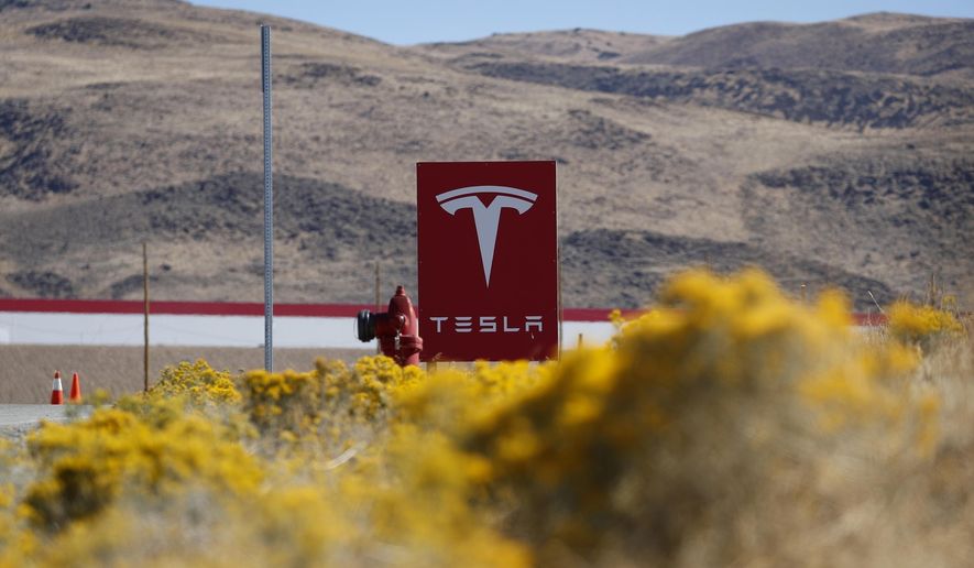 A sign marks the entrance to the Tesla Gigafactory, Oct. 13, 2018, in Sparks, Nev. (AP Photo/John Locher, File)