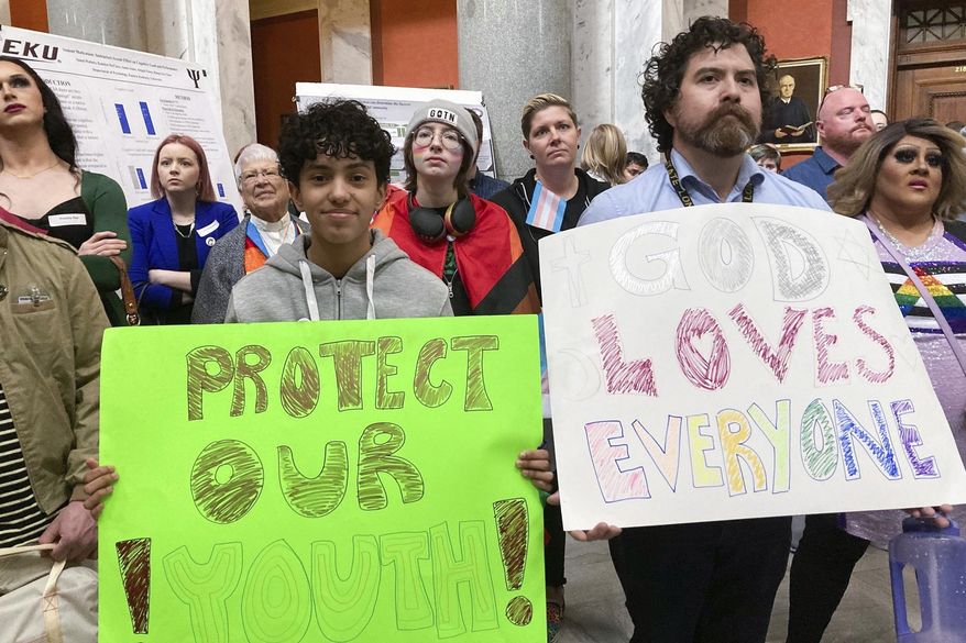 Transgender-rights advocates gather near the Kentucky House chamber, Thursday, March 2, 2023, in Frankfort, Ky. The House passed a bill to ban access to gender-transition medical care for people under age 18. (AP Photo/Bruce Schreiner)