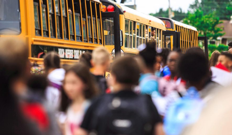 FILE - Students at Paducah Middle School get onto buses at the end of their first day of class on August 9, 2018, in Paducah, Ky. The Kentucky House passed a school discipline bill Friday, March 3, 2023, that&#x27;s aimed at defusing classroom disruptions by allowing teachers to take immediate action to remove unruly students. (Ellen O&#x27;Nan/The Paducah Sun via AP, File)