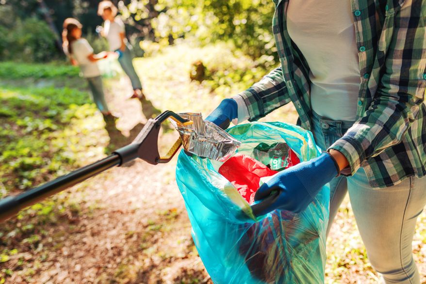 Volunteers cleaning up the park. File photo credit: Stock-Asso via Shutterstock.