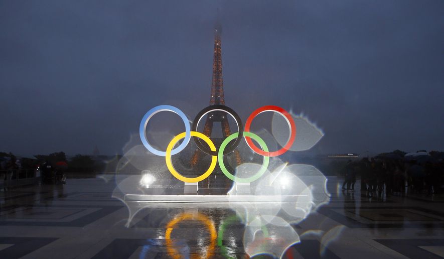 The Olympic rings are seen on the Place du Trocadero that overlooks the Eiffel Tower, after the vote in Lima, Peru, awarding the 2024 Games to the French capital, in Paris, Sept. 13, 2017. Organizers of the Paris 2024 Olympics promised Games with a relatively modest price tag and &quot;egalitarian&quot; access to events, thanks to an online draw meant to revolutionize ticket sales and bring the masses to next year&#x27;s Olympics with prices as low as 24 euros ($26). But as the first round of ticketing winds down, many &quot;lucky&quot; winners chosen for the draw are feeling frustrated, angry and cheated, as their only option during the 48-hour purchasing window was paying at least 200 euros per ticket for the few remaining events on offer. (AP Photo/Francois Mori, File)