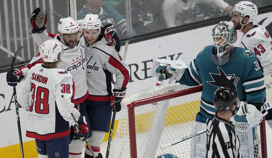 Washington Capitals left wing Alex Ovechkin, second from left, is congratulated by defenseman Rasmus Sandin (38) and defenseman Vincent Iorio after scoring a goal past San Jose Sharks goaltender Kaapo Kahkonen during the third period of an NHL hockey game in San Jose, Calif., Saturday, March 4, 2023. (AP Photo/Jeff Chiu) **FILE**