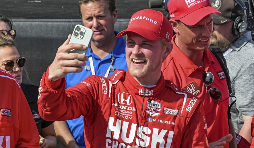 Huski Chocolate Chip Ganassi Racing driver Marcus Ericsson makes a video call in Victory Lane after winning the Grand Prix of St. Petersburg auto race Sunday, March 5, 2023, in St. Petersburg, Fla. (AP Photo/Steve Nesius)