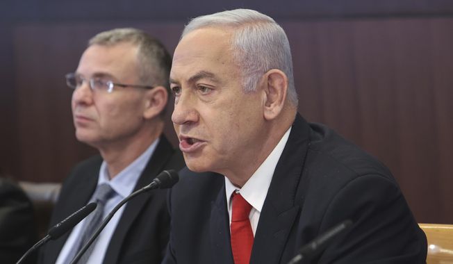 Israeli Prime Minister Benjamin Netanyahu, right, chairs the weekly cabinet meeting at the Prime Minister&#x27;s office in Jerusalem, Sunday March 5, 2023. (Gil Cohen-Magen/Pool via AP)