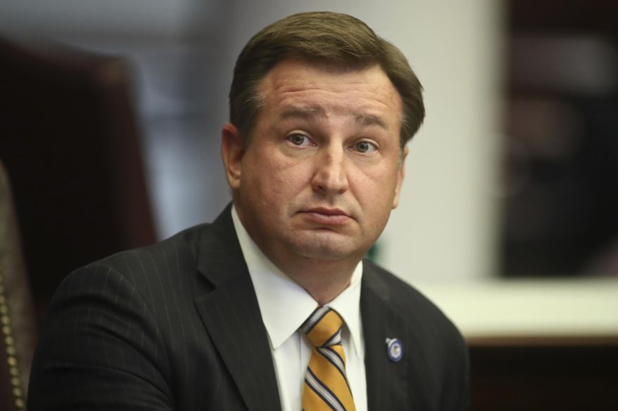 State Sen. Jason Brodeur, R-Sanford, stis at his desk in the Florida Senate, May 24, 2022 at the Capitol in Tallahassee, Fla. The Republican lawmaker wants bloggers who write about elected officials to register with the state. The bill filed by Sen. Brodeur would require bloggers to file periodic reports with the state if they are paid for posts about the state’s governor, lieutenant governor, cabinet members or legislative officials. (AP Photo/Phil Sears)