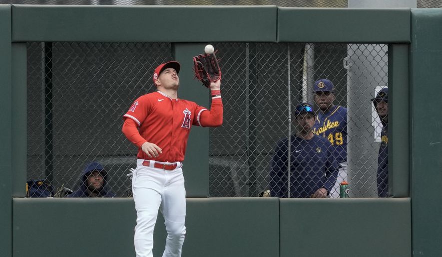 Los Angeles Angels&#x27; Mike Trout catches a fly ball near the wall hit by Milwaukee Brewers&#x27; Keston Hiura during the fifth inning of a spring training baseball game Wednesday, March 1, 2023, in Tempe, Ariz. (AP Photo/Morry Gash) **FILE**