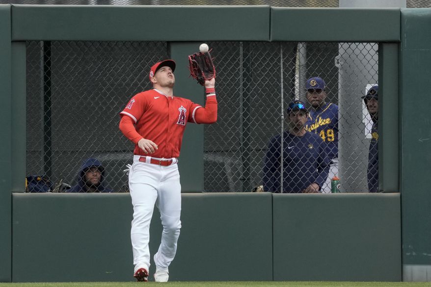 Los Angeles Angels&#x27; Mike Trout catches a fly ball near the wall hit by Milwaukee Brewers&#x27; Keston Hiura during the fifth inning of a spring training baseball game Wednesday, March 1, 2023, in Tempe, Ariz. (AP Photo/Morry Gash) **FILE**