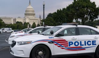 Washington Metropolitan Police vehicles hold on the perimeter of the Capitol in Washington, Aug. 26, 2021. The head of the D.C. Council said Monday, March 6, 2023, that he is withdrawing the capital city’s new criminal code from consideration, just before a U.S. Senate vote that seemed likely to overturn the measure. But it&#x27;s unclear if the action will prevent the vote or spare President Joe Biden a politically charged decision on whether to endorse the congressional action. (AP Photo/J. Scott Applewhite) **FILE**