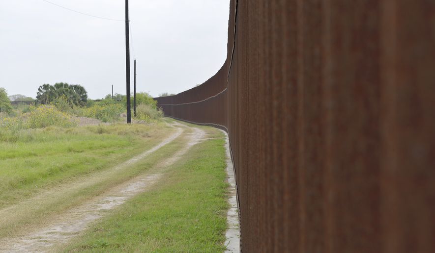 The U.S. border fence stretches across Rusty Monsees&#x27; 21.1-acre property on April 30, 2017, in Brownsville, Texas. (Miguel Roberts/The Brownsville Herald via AP, File)