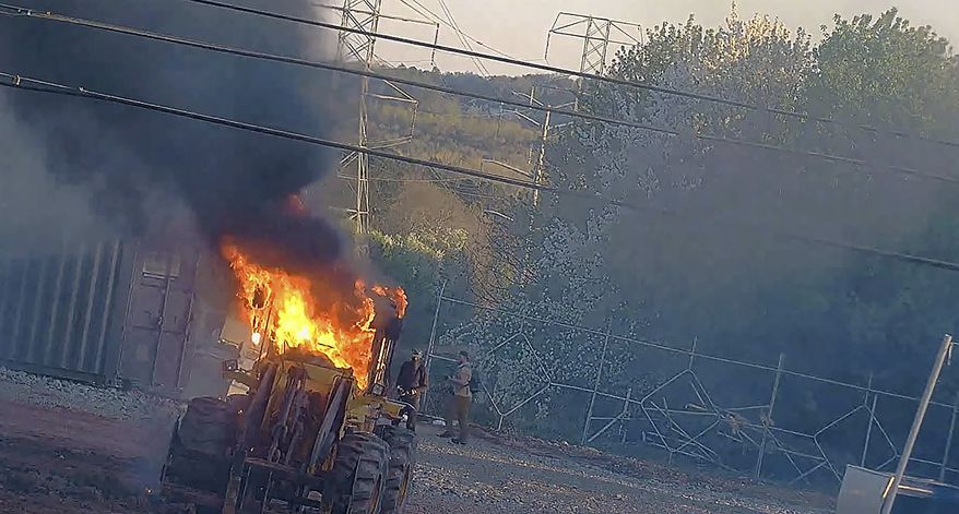 This image provided by the Atlanta Police Department shows construction equipment set on fire Saturday, March 4, 2023 by a group protesting the planned public safety training center, according to police. (Atlanta Police Department via AP)