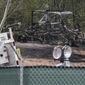 Damaged equipment sits at the Atlanta Public Safety Training Center in DeKalb County, Ga., Monday, March 6, 2023. More than 20 people from around the country faced domestic terrorism charges Monday after dozens of young men in black masks attacked the site of a police training center under construction in a wooded area outside Atlanta where one protester was killed in January. (John Spink/Atlanta Journal-Constitution via AP)