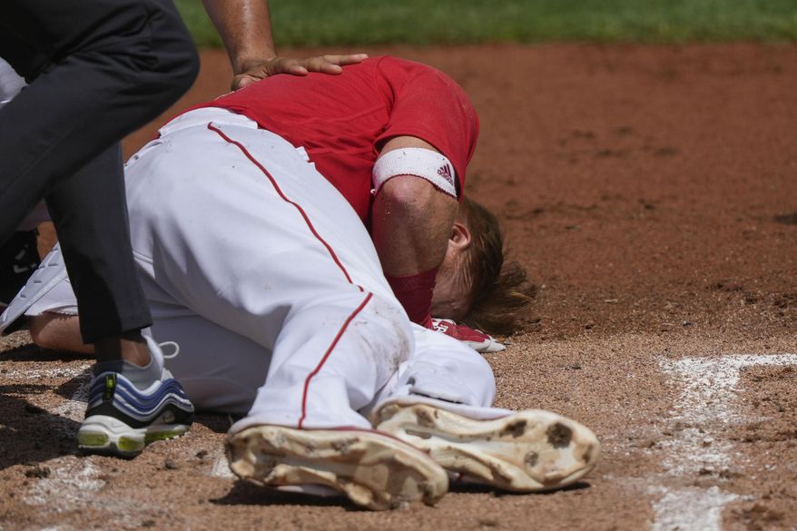 Boston Red Sox Justin Turner rolls on the ground after being hit in the face on a pitch by Detroit Tigers starting pitcher Matt Manning in the first inning of their spring training baseball game in Fort Myers, Fla., Monday, March 6, 2023. (AP Photo/Gerald Herbert)