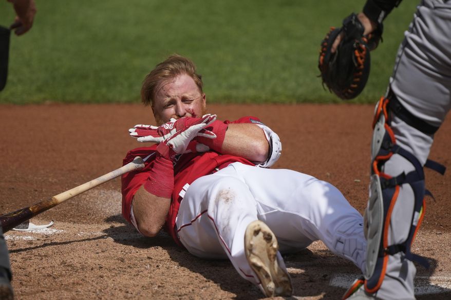 Boston Red Sox Justin Turner reacts after being hit in the face on a pitch by Detroit Tigers starting pitcher Matt Manning in the first inning of their spring training baseball game in Fort Myers, Fla., Monday, March 6, 2023. (AP Photo/Gerald Herbert)