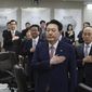 South Korean President Yoon Suk Yeol, foreground, salutes to a national flag during a Cabinet meeting at the presidential office in Seoul, South Korea, Tuesday, March 7, 2023. Yoon on Tuesday defended his government&#x27;s contentious plan to use local funds to compensate Koreans enslaved by Japanese companies before the end of World War II, saying it&#x27;s crucial for Seoul to build future-oriented ties with its former colonial overlord. (Im Hun-jung/Yonhap via AP)