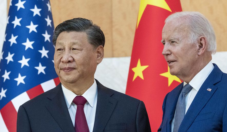 U.S. President Joe Biden, right, stands with Chinese President Xi Jinping before a meeting on the sidelines of the G20 summit meeting on Nov. 14, 2022, in Bali, Indonesia. Xi accused Washington on Monday, March 6, 2023, trying to isolate his country and hold back its development. That reflects the ruling Communist Party&#x27;s growing frustration that its pursuit of prosperity and global influence is threatened by U.S. restrictions on access to technology, its support for Taiwan and other moves seen by Beijing as hostile. (AP Photo/Alex Brandon) **FILE**