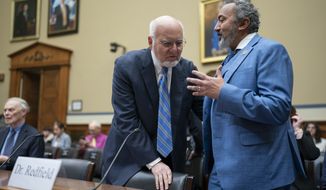 Dr. Robert Redfield, left, former director of the U.S. Centers for Disease Control and Prevention, confers with Rep. Ami Bera, D-Calif., before the start of a hearing by the House Select Subcommittee on the Coronavirus Pandemic, at the Capitol in Washington, Wednesday, March 8, 2023. (AP Photo/J. Scott Applewhite)