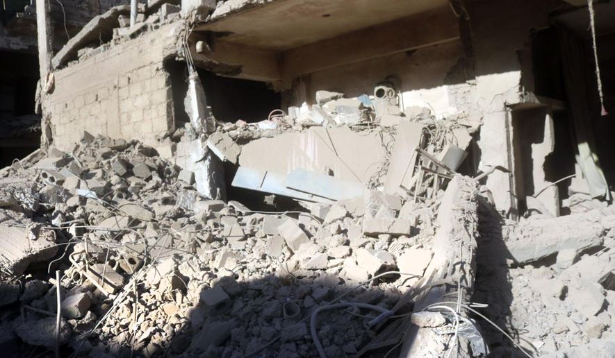 In this photo released by the Syrian official news agency SANA, shows rubble at a destroyed building with a hit by an explosion, in Deir el-Zour, Syria, Wednesday, March 8, 2023. An explosion in eastern Syria killed people, according to reports. A war monitoring group said the blast was likely caused by a drone strike that targeted Iran-backed militiamen. (SANA via AP) ** FILE **