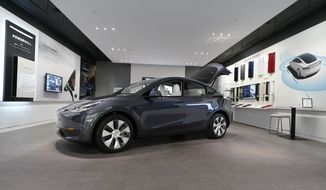 A Tesla Model Y Long Range is displayed on Feb. 24, 2021, at the Tesla Gallery in Troy, Mich. U.S. auto safety regulators have opened an investigation into Tesla’s Model Y SUV after getting two complaints that the steering wheels can come off while being driven. The National Highway Traffic Safety Administration says the probe covers an estimated 120,000 vehicles from the 2023 model year.  (AP Photo/Carlos Osorio, File)