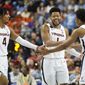 Virginia players, from left to right, Armaan Franklin, Jayden Gardner and Reece Beekman celebrate during the second half of an NCAA college basketball game against North Carolina at the Atlantic Coast Conference Tournament in Greensboro, N.C., Thursday, March 9, 2023. (AP Photo/Chuck Burton)