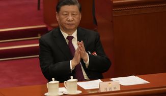 Chinese President Xi Jinping applauds during a session of China&#x27;s National People&#x27;s Congress (NPC) at the Great Hall of the People in Beijing, Friday, March 10, 2023. (AP Photo/Mark Schiefelbein)