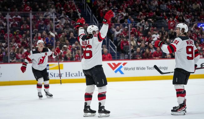 New Jersey Devils left wing Erik Haula (56) with center Dawson Mercer (91) celebrates his goal in the second period of an NHL hockey game against the Washington Capitals, Thursday, March 9, 2023, in Washington. (AP Photo/Alex Brandon)