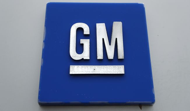 The General Motors logo is displayed outside the General Motors Detroit-Hamtramck Assembly plant, Jan. 27, 2020, in Hamtramck, Mich. General Motors is offering buyouts to most of its U.S. salaried workforce and some global executives in an effort to trim costs as it makes the transition to electric vehicles. (AP Photo/Paul Sancya, File)