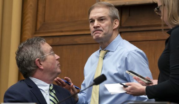 Chairman Jim Jordan, R-Ohio talks to Rep. Thomas Massie, R-Ky., during a House Judiciary subcommittee hearing on what Republicans say is the politicization of the FBI and Justice Department and attacks on American civil liberties on Capitol Hill in Washington, Thursday, March 9, 2023. (AP Photo/Manuel Balce Ceneta)