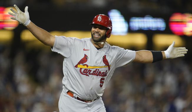 FILE - St. Louis Cardinals designated hitter Albert Pujols (5) reacts after hitting his 700th home run during the fourth inning of a baseball game against the Los Angeles Dodgers in Los Angeles on Sept. 23, 2022. Pujols said Thursday, March 9, 2023, he believes he will eventually return to baseball as a coach during a stop at St. Louis Cardinals&#x27; camp.(AP Photo/Ashley Landis, File)