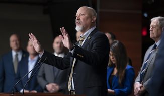 Rep. Chip Roy, R-Texas, center, stands with members of the House Freedom Caucus as he speaks during a press conference at the Capitol in Washington, Friday, March 10, 2023. (AP Photo/J. Scott Applewhite)