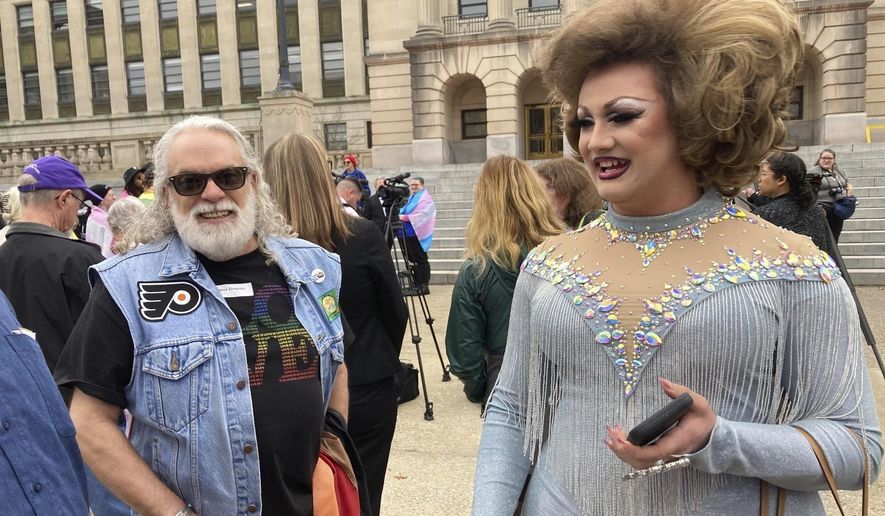 Drag performer Poly Tics, right, attends a rally in Frankfort, Ky., Thursday, March 2, 2023. Republican lawmakers in Kentucky advanced a bill Friday, March 10, 2023, to put limits on drag shows, capping a free-wielding Senate debate as supporters touted it as a child-protection measure and opponents called it an unconstitutional attack aimed at LGTBQ groups. (AP Photo/Bruce Schreiner, File)