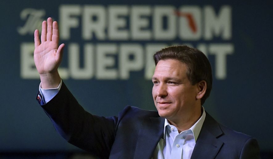 Florida Gov. Ron DeSantis waves to the crowd as he attends an event Friday, March 10, 2023, in Davenport, Iowa. (AP Photo/Ron Johnson)