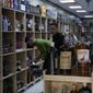 People buy alcohol in a liquor store in Baghdad, Iraq, Thursday, March 9, 2023. The Iraqi government started enforcing a 2016 ban on alcoholic beverages this month, although many liquor shops remained open in Baghdad. (AP Photo/Hadi Mizban)