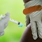 A health worker administers a dose of COVID-19 vaccine during a vaccination clinic in Reading, Pa. on Sept. 14, 2021.  On Friday, March 10, 2023, The Associated Press reported on stories circulating online incorrectly claiming the U.S. military has recorded a 500% increase in new HIV infections since COVID-19 vaccines were introduced. (AP Photo/Matt Rourke, File)
