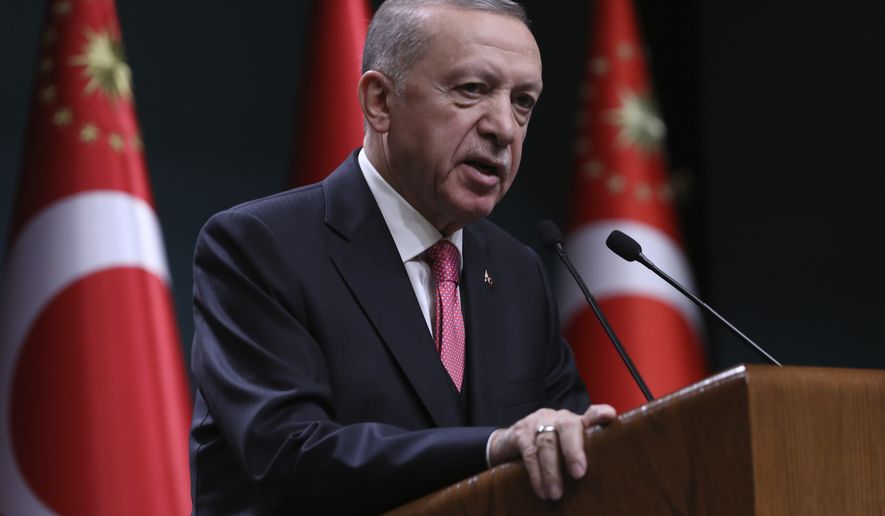 Turkey's President Recep Tayyip Erdogan speaks after he signed a decision confirming the election date, in Ankara, Turkey, Friday, March 10, 2023. Erdogan, who is seeking to extend his two decades in power, on Friday formally set the country's parliamentary and presidential elections for May 14 — a month earlier than scheduled despite last month's devastating earthquake. (AP Photo/Burhan Ozbilici)