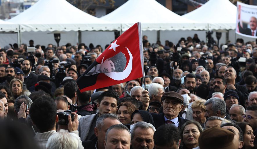 A man holding a flag with an image of Turkey&#x27;s founder Mustafa Kemal Ataturk waits with others as Kemal Kilicdaroglu, the leader of the pro-secular, center-left Republican People&#x27;s Party, or CHP, is nominated by a six-party alliance as its common candidate to challenge President Recep Tayyip Erdogan, in Ankara, Turkey, March 6, 2023. The alliance on Monday nominated main opposition party leader Kilicdaroglu to challenge Erdogan in elections in May, ending months of uncertainty and bickering that had frustrated their supporters. (AP Photo/Burhan Ozbilici)
