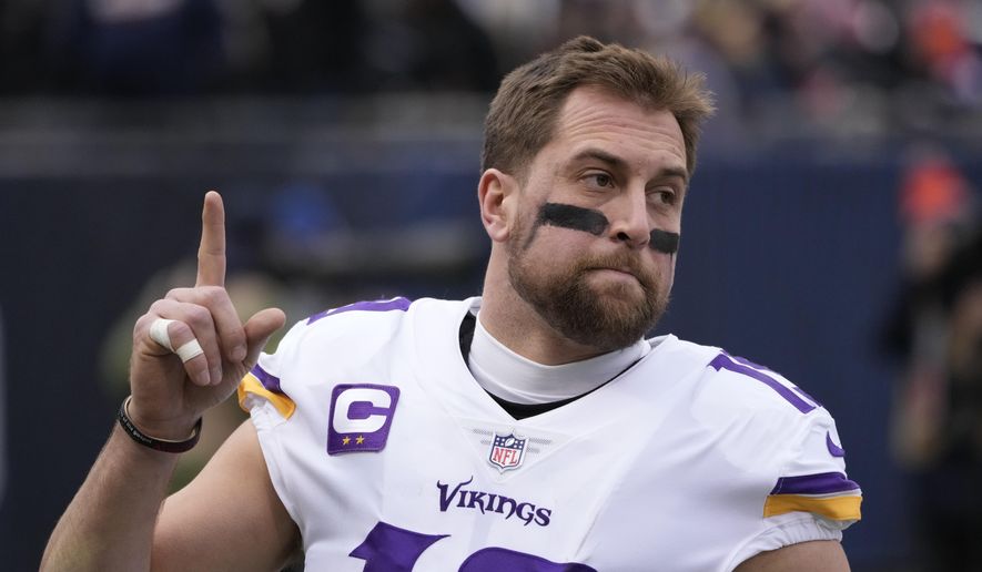 Minnesota Vikings' Adam Thielen points skyward before an NFL football game against the Chicago Bears Sunday, Jan. 8, 2023, in Chicago. The Vikings released wide receiver Adam Thielen on Friday, March 10, 2023, for salary cap relief, ending a remarkable 10-year run with his home-state team as an undrafted underdog.(AP Photo/Charles Rex Arbogast, File)