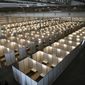 Cots fill Tecnopolis Park in Buenos Aires, Argentina, Friday, April 17, 2020. Authorities set up the field hospital in this space that normally hosts museum exhibits, fairs and other attractions, to take in patients with mild COVID-19 symptoms if necessary. (AP Photo/Victor R. Caivano, File)