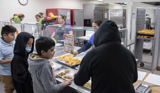 Students select their meal during lunch break in the cafeteria at V. H. Lassen Academy of Science and Nutrition in Phoenix, Tuesday, Jan. 31, 2023. (AP Photo/Alberto Mariani)