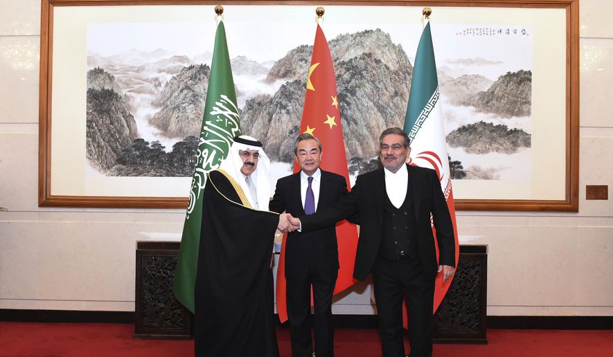 In this photo released by Xinhua News Agency, Ali Shamkhani, the secretary of Iran&#x27;s Supreme National Security Council, at right, shakes hands with Saudi National Security Adviser Musaad bin Mohammed al-Aiban, at left, as Wang Yi, China&#x27;s most senior diplomat, looks on, at center, for a photo during a closed meeting held in Beijing, Saturday, March 11, 2023. Iran and Saudi Arabia agreed Friday to reestablish diplomatic relations and reopen embassies after seven years of tensions. The major diplomatic breakthrough negotiated with China lowers the chance of armed conflict between the Mideast rivals, both directly and in proxy conflicts around the region. (Luo Xiaoguang/Xinhua via AP)